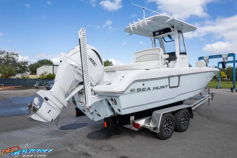 Slide: The Image of 2023 Sea Hunt Escape 23 boat on trailer, featuring Yamaha outboard motor. - 10