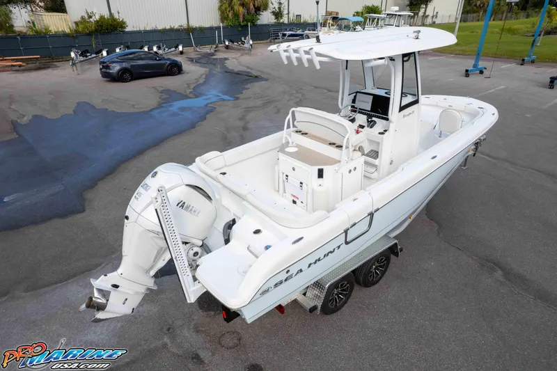 Slide: The Image of 2023 Sea Hunt Escape 23 boat with Yamaha engine on trailer in parking lot. - 11