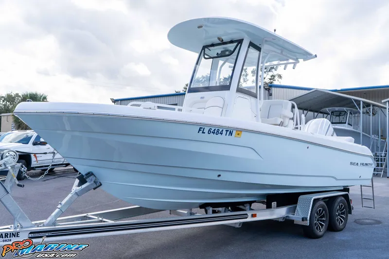 Slide: The Image of 2023 Sea Hunt Escape 23 boat on trailer, displayed outdoors. - 20