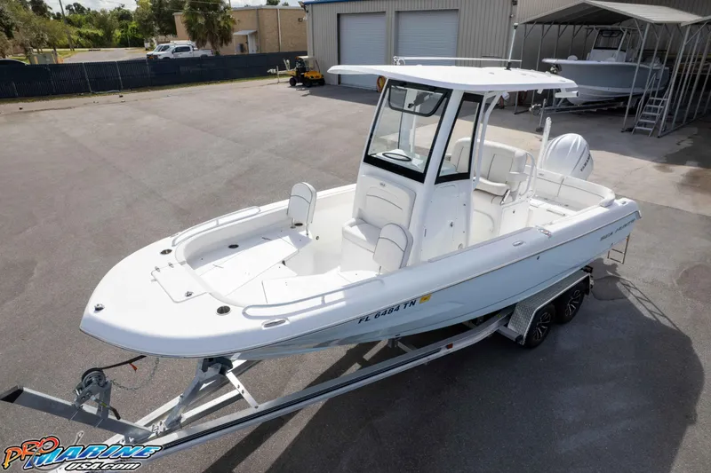 Slide: The Image of 2023 Sea Hunt Escape 23 boat on trailer in outdoor storage area. - 3