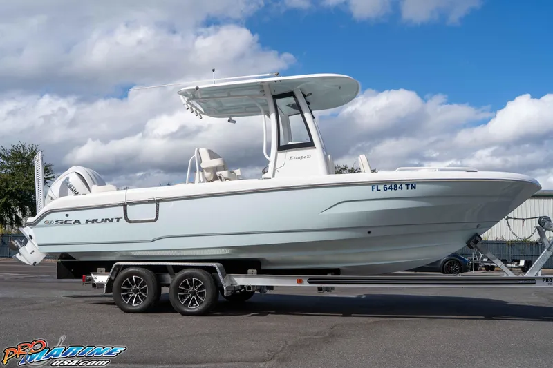 Slide: The Image of 2023 Sea Hunt Escape 23 boat on trailer under blue sky. - 30
