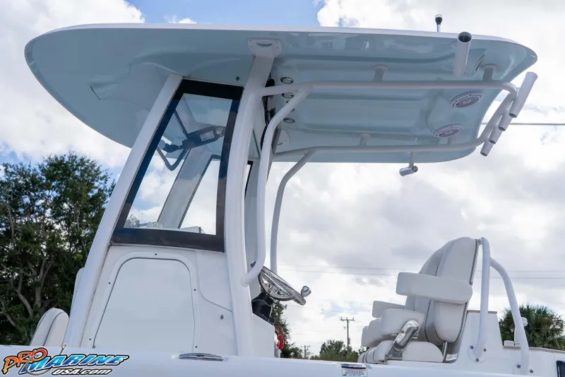 Slide: The Image of 2023 Sea Hunt Escape 23 boat with T-top and seating, under a cloudy sky. - 35