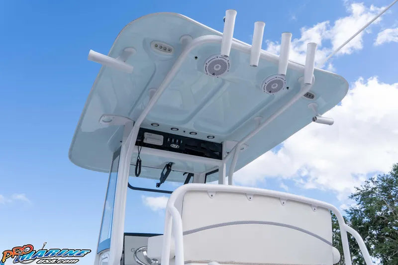 Slide: The Image of 2023 Sea Hunt Escape 23 boat with T-top and rod holders against blue sky. - 36