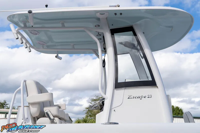 Slide: The Image of 2023 Sea Hunt Escape 23 boat with sleek design and modern features under a cloudy sky. - 37