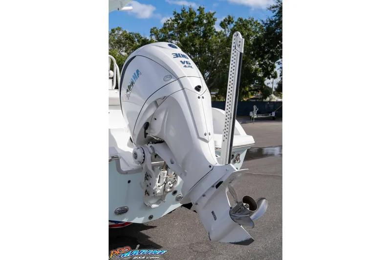 Slide: The Image of 2023 Sea Hunt Escape 23 with Yamaha 300 V6 outboard motor, parked outdoors. - 39
