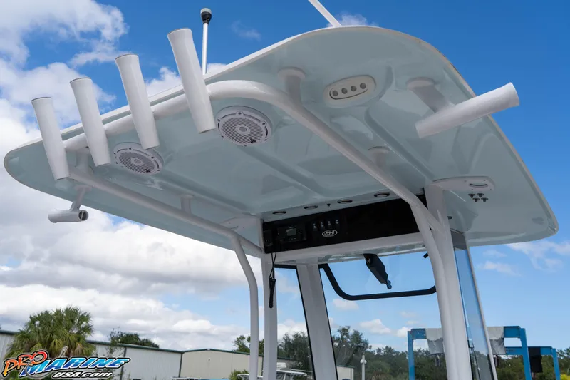 Slide: The Image of 2023 Sea Hunt Escape 23 boat with T-top and rod holders under a blue sky. - 44