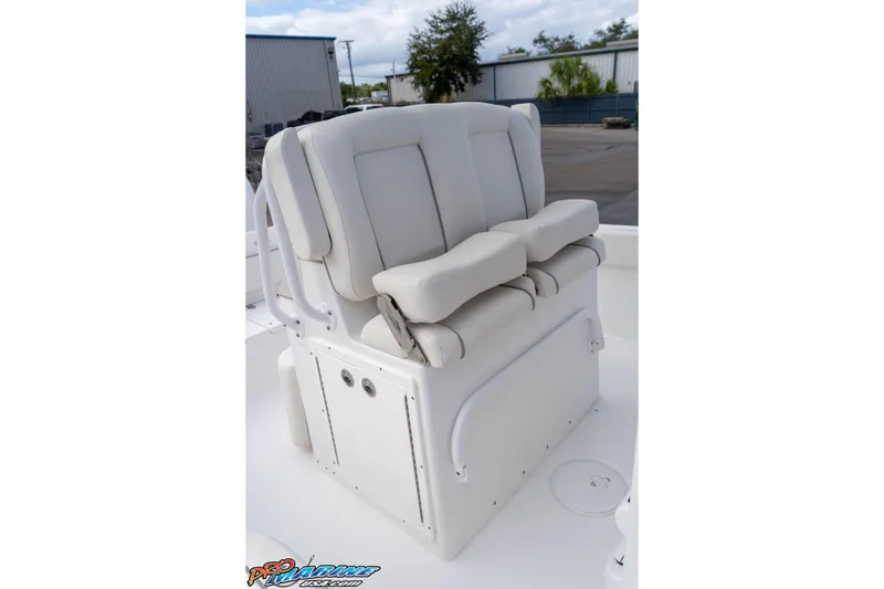 Slide: The Image of 2023 Sea Hunt Escape 23 boat seat with cushioned backrest and armrests. - 45