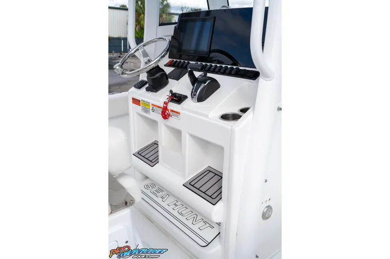 Slide: The Image of 2023 Sea Hunt Escape 23 boat console with steering wheel and controls. - 47