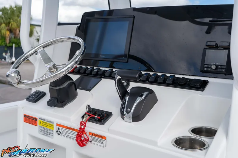 Slide: The Image of 2023 Sea Hunt Escape 23 boat dashboard with steering wheel and controls. - 48