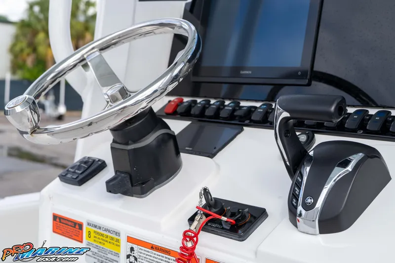 Slide: The Image of Steering console of 2023 Sea Hunt Escape 23 boat with controls and display. - 49