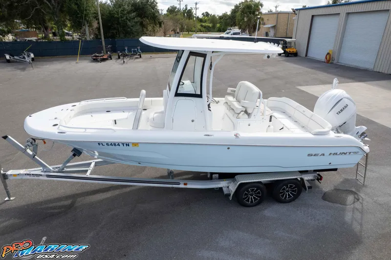 Slide: The Image of 2023 Sea Hunt Escape 23 boat on trailer, featuring Yamaha engine, parked outdoors. - 5