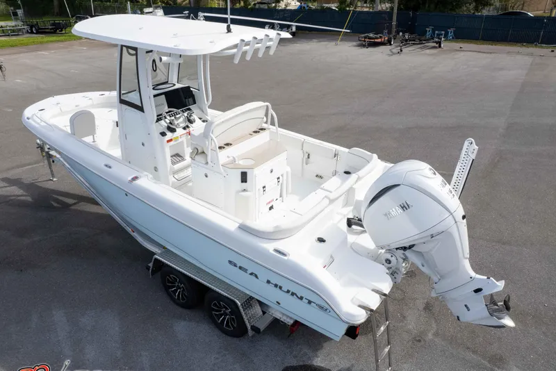 Slide: The Image of 2023 Sea Hunt Escape 23 boat with Yamaha outboard engine, parked on a trailer. - 7