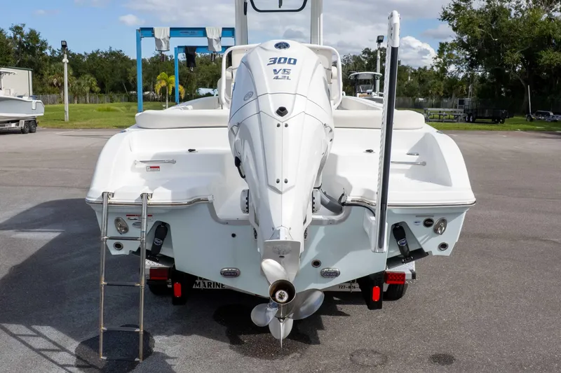 Slide: The Image of 2023 Sea Hunt Escape 23 boat with powerful outboard motor, parked on a sunny day. - 8