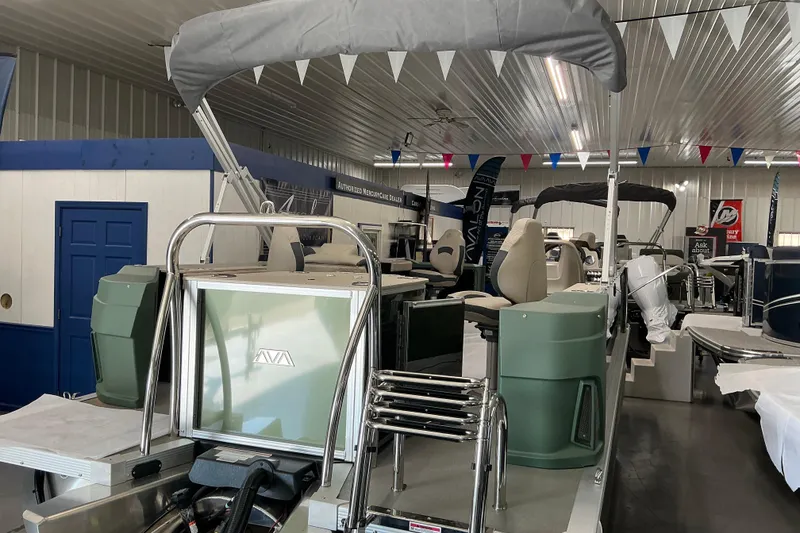 Slide: The Image of 2026 Avalon GeoFish Quad Fish boat in showroom, featuring modern seating and equipment. - 6