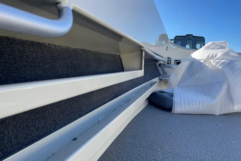 Slide: The Image of 2026 Hewescraft 200 Pioneer boat interior with storage compartments and protective covering. - 10