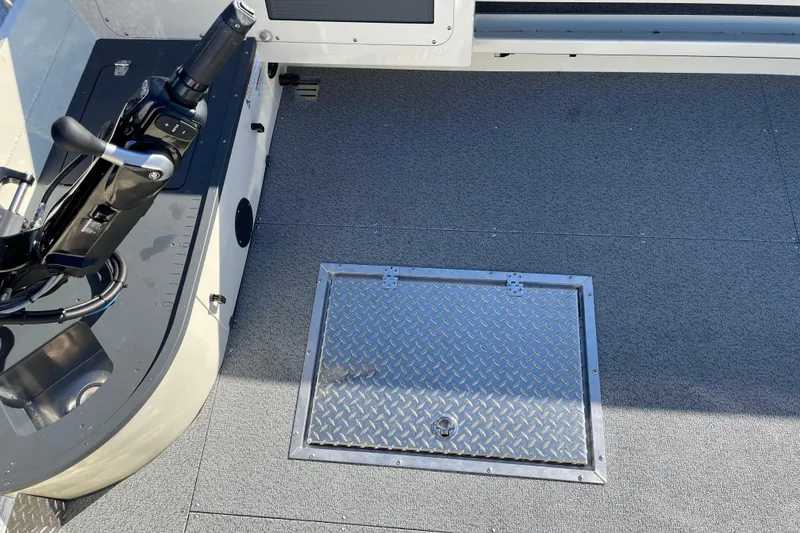Slide: The Image of Interior of 2026 Hewescraft 200 Pioneer boat, featuring control panel and diamond plate hatch. - 15