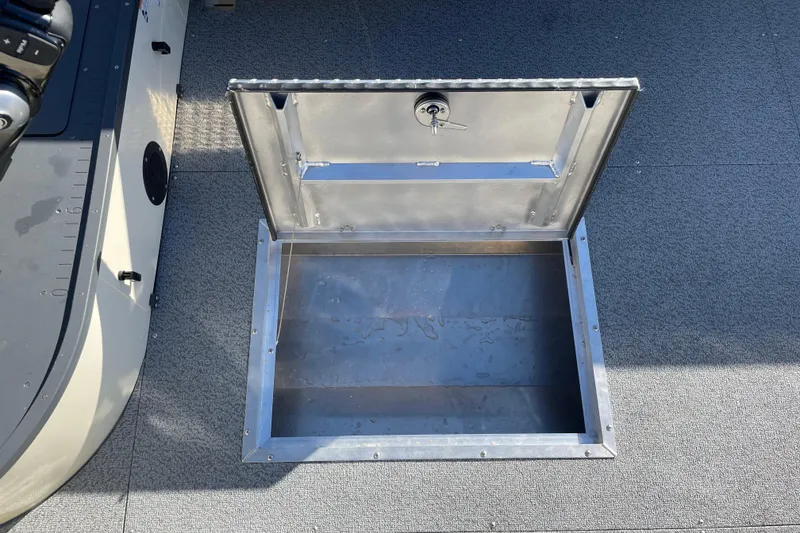 Slide: The Image of Open storage compartment on 2026 Hewescraft 200 Pioneer boat deck. - 16