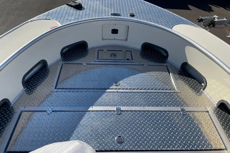 Slide: The Image of 2026 Hewescraft 200 Pioneer boat deck with diamond plate flooring and storage compartments. - 17