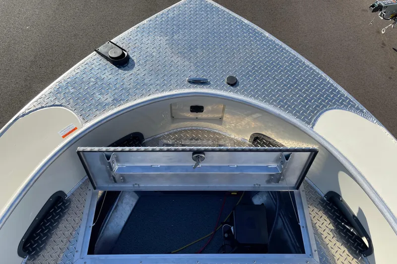 Slide: The Image of 2026 Hewescraft 200 Pioneer boat with open storage compartment on diamond plate deck. - 18