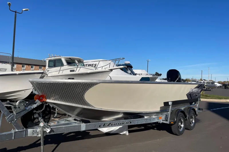 Slide: The Image of 2026 Hewescraft 200 Pioneer boat on trailer under clear blue sky. - 2