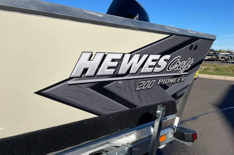 Slide: The Image of 2026 Hewescraft 200 Pioneer boat with bold logo on trailer. - 21
