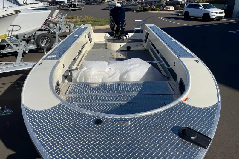 Slide: The Image of 2026 Hewescraft 200 Pioneer boat with aluminum deck, parked in a marina. - 3