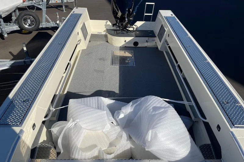 Slide: The Image of 2026 Hewescraft 200 Pioneer boat interior with protective wrapping, showcasing spacious deck layout. - 4