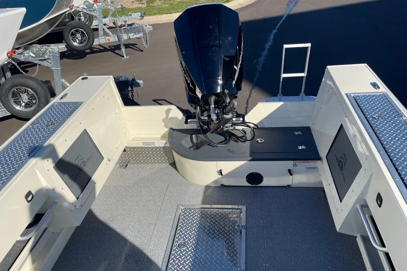 Slide: The Image of 2026 Hewescraft 200 Pioneer boat interior with motor, diamond plate flooring, and storage compartments. - 5