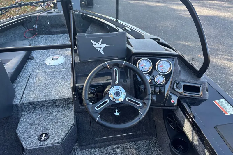 Slide: The Image of 2026 Tracker Targa V-19 Combo boat on trailer, parked near autumn trees. - 2