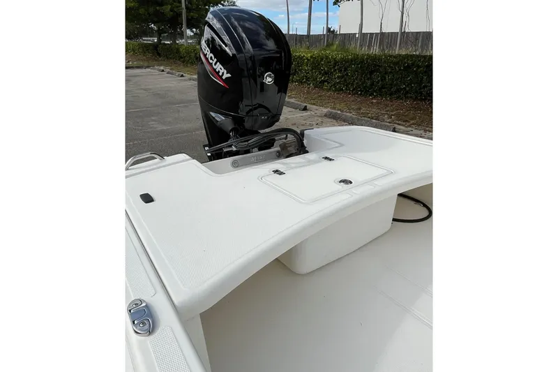 Slide: The Image of 2026 Mako Pro Skiff 17 CC boat with Mercury outboard motor, parked outdoors. - 11