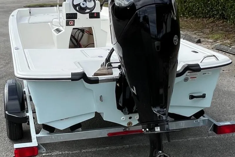 Slide: The Image of 2026 Mako Pro Skiff 17 CC boat on trailer, rear view with outboard motor. - 53