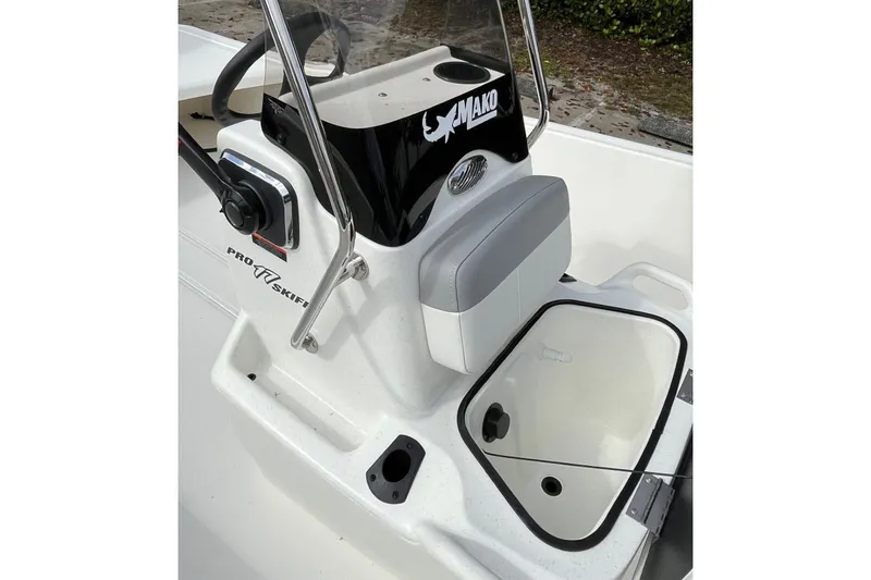 Slide: The Image of 2026 Mako Pro Skiff 17 CC boat console with steering wheel and storage compartment. - 7
