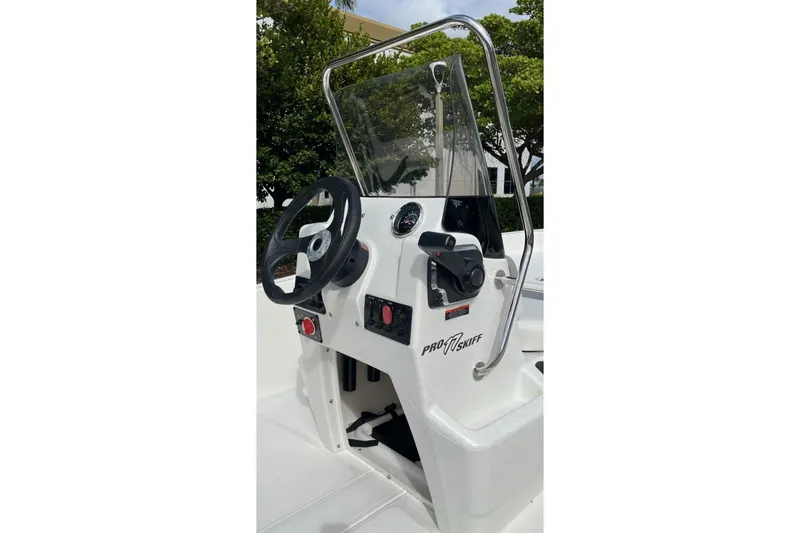 Slide: The Image of 2026 Mako Pro Skiff 17 CC boat console with steering wheel and controls. - 9