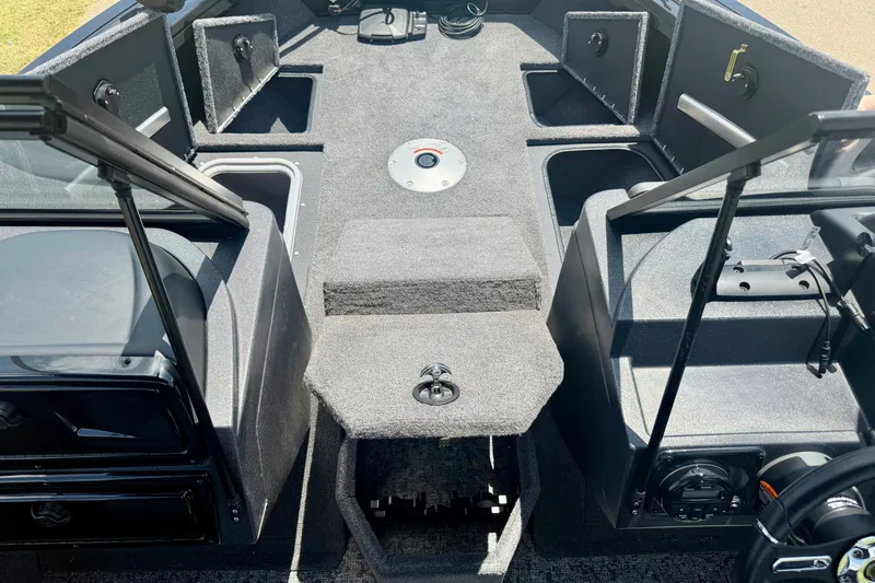 Slide: The Image of 2026 Tracker Targa V-19 WT boat interior with storage compartments and seating. - 9