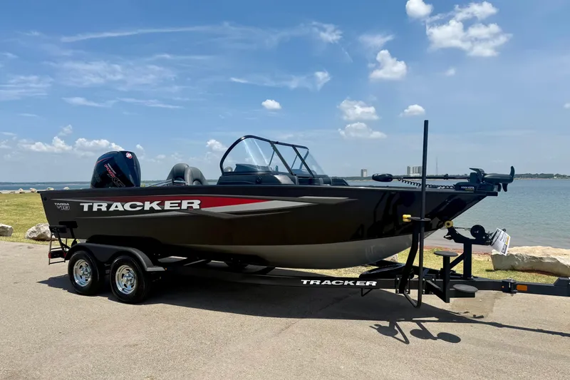The Image of 2026 Tracker Targa V-19 WT boat on trailer by a scenic lakeside. - 0