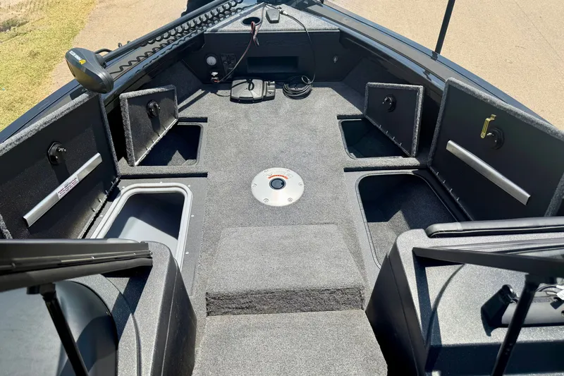 Slide: The Image of 2026 Tracker Targa V-19 WT boat interior with storage compartments and fishing equipment. - 10