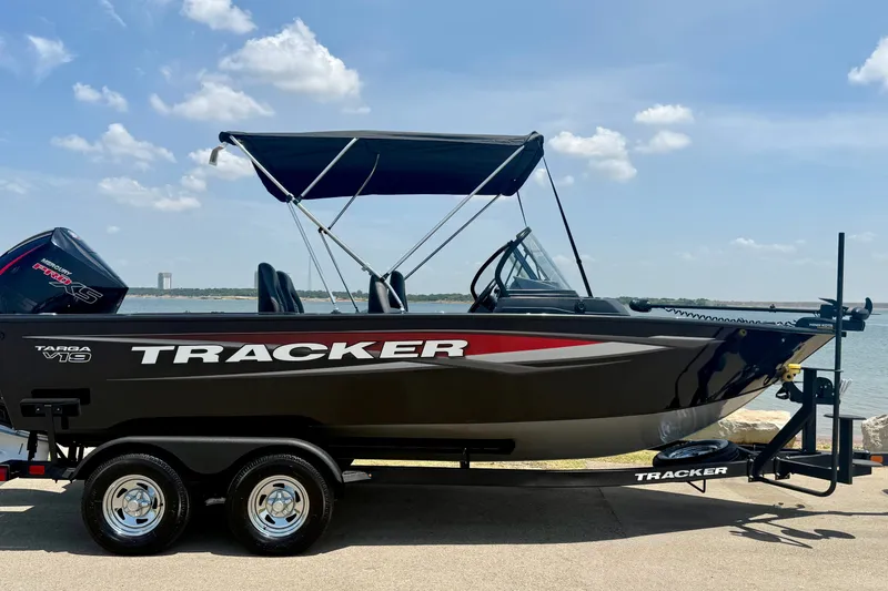 Slide: The Image of 2026 Tracker Targa V-19 WT boat on trailer by the water. - 6