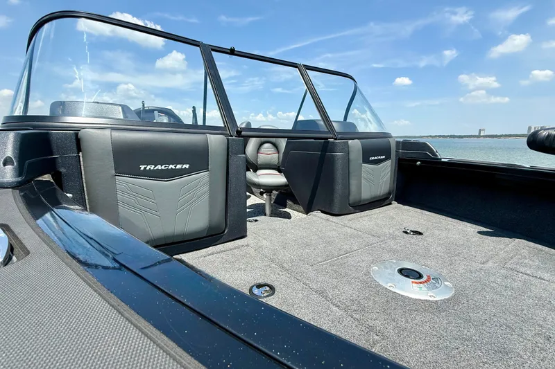 Slide: The Image of 2026 Tracker Targa V-19 WT boat interior with spacious seating and sleek design on a sunny day. - 2