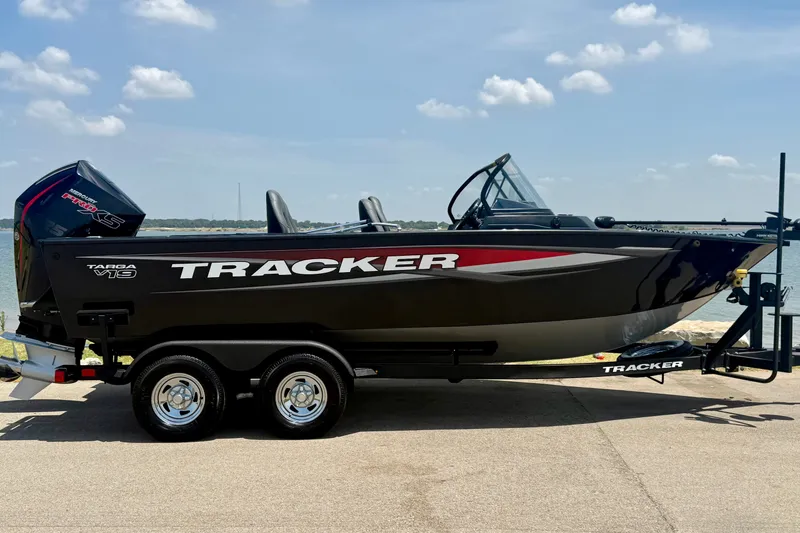 Slide: The Image of 2026 Tracker Targa V-19 WT boat on trailer by a lake under a clear sky. - 3