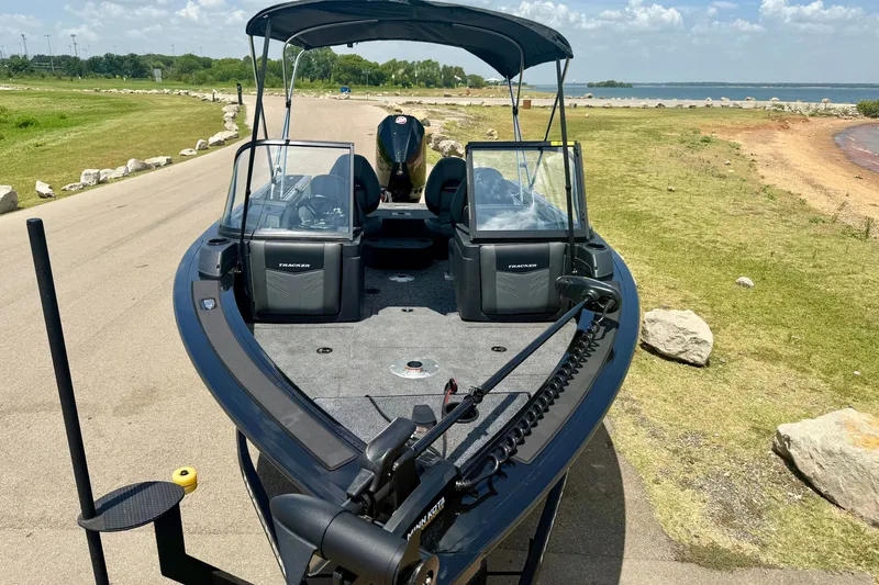 Slide: The Image of 2026 Tracker Targa V-19 WT boat on a lakeside road, under a clear sky. - 15