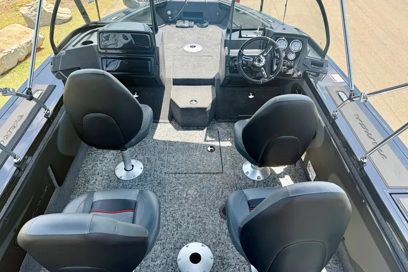 Slide: The Image of Interior of 2026 Tracker Targa V-19 WT boat with four seats and modern dashboard. - 12