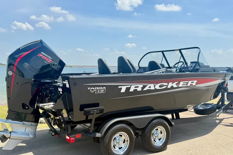 Slide: The Image of 2026 Tracker Targa V-19 WT boat with Mercury Pro XS engine on trailer by lake. - 4