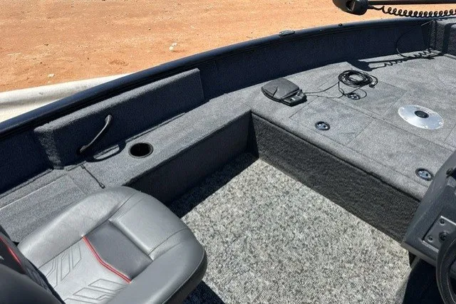 Slide: The Image of The image shows the interior of a Tracker Pro Guide V-16 SC boat with gray seats and carpeted flooring. - 14