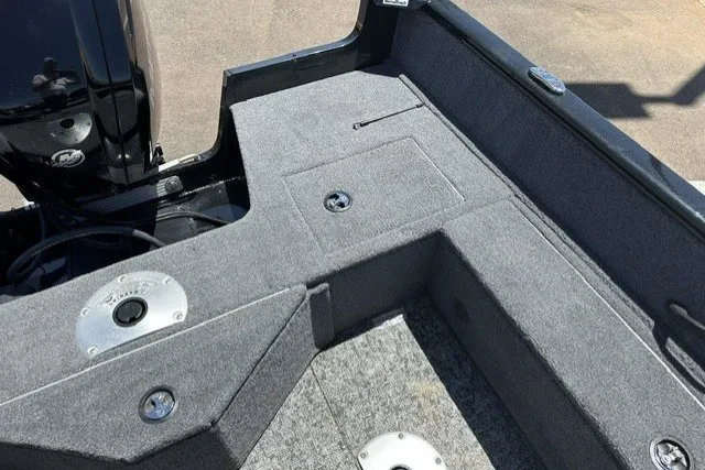 Slide: The Image of 2026 Tracker Pro Guide V-16 SC boat interior with carpeted deck and storage compartments. - 15