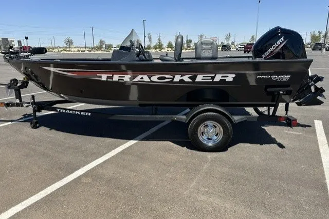The Image of A 2026 Tracker Pro Guide V-16 SC boat on a trailer in a parking lot. - 0