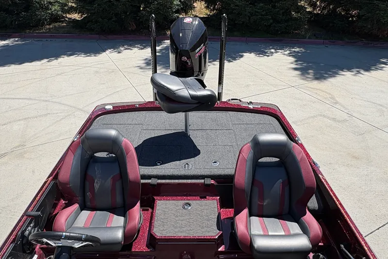 Slide: The Image of 2026 Nitro Z21 XL Pro boat interior with dual seats and motor, parked outdoors. - 12