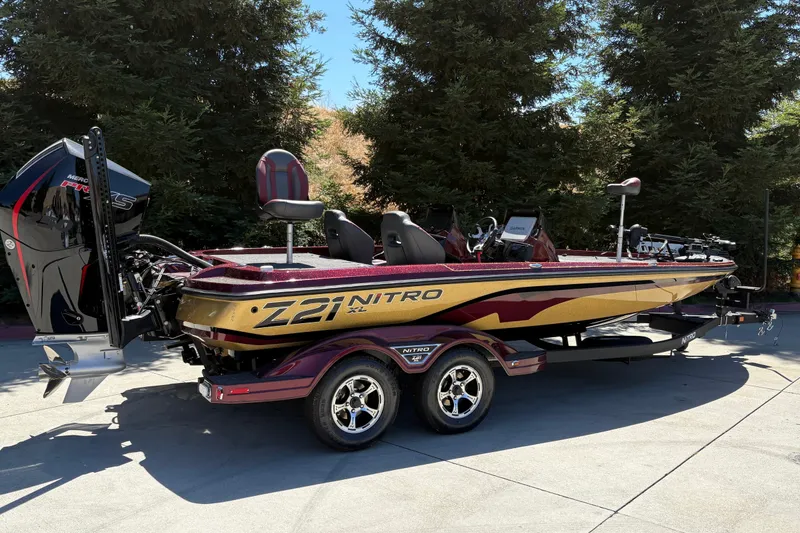 Slide: The Image of 2026 Nitro Z21 XL Pro boat on trailer, parked outdoors. - 2