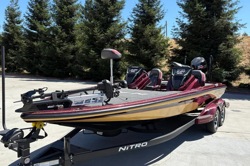 Slide: The Image of 2026 Nitro Z21 XL Pro bass boat on trailer, parked outdoors. - 5