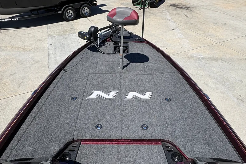 Slide: The Image of 2026 Nitro Z21 XL Pro boat deck with seating and equipment, parked on concrete. - 14