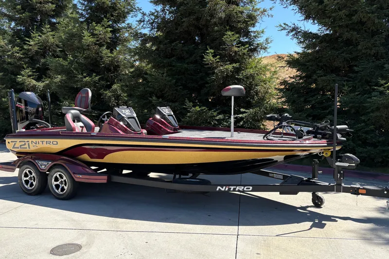 Slide: The Image of 2026 Nitro Z21 XL Pro bass boat on trailer, parked outdoors. - 7